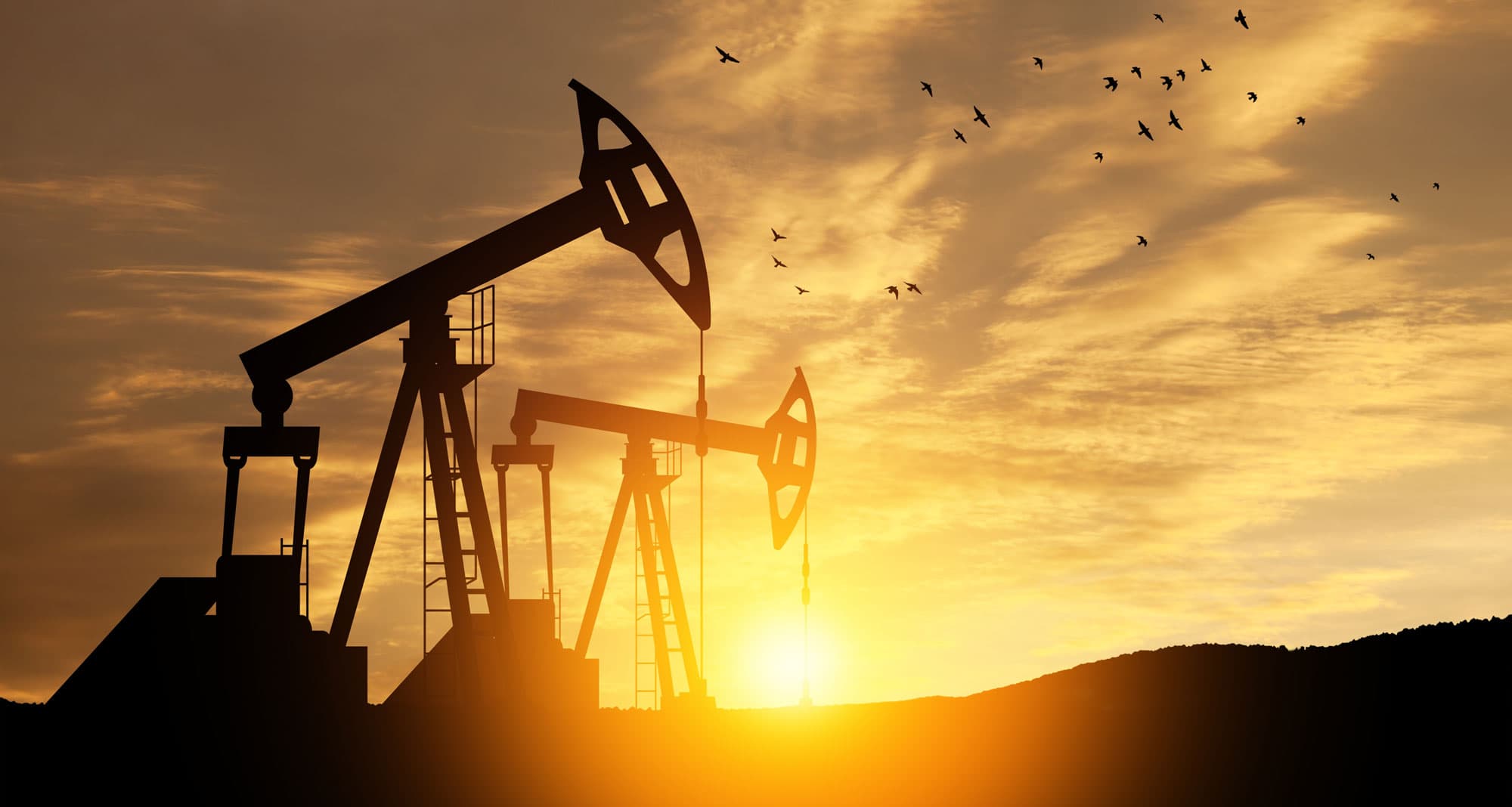 Oil well pumpjack at sunset